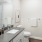 bath with sink toilet and large mirror